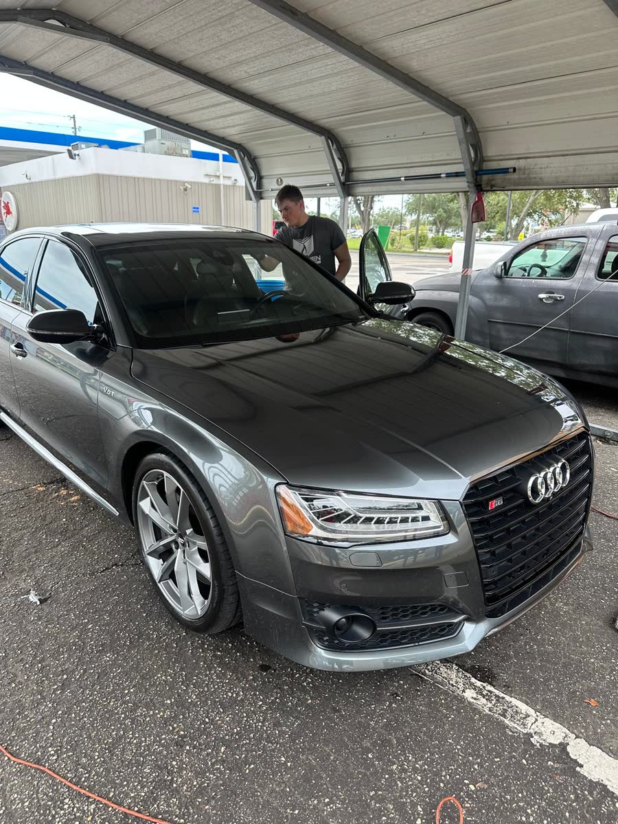 Gray Audi sedan detailed under the carport