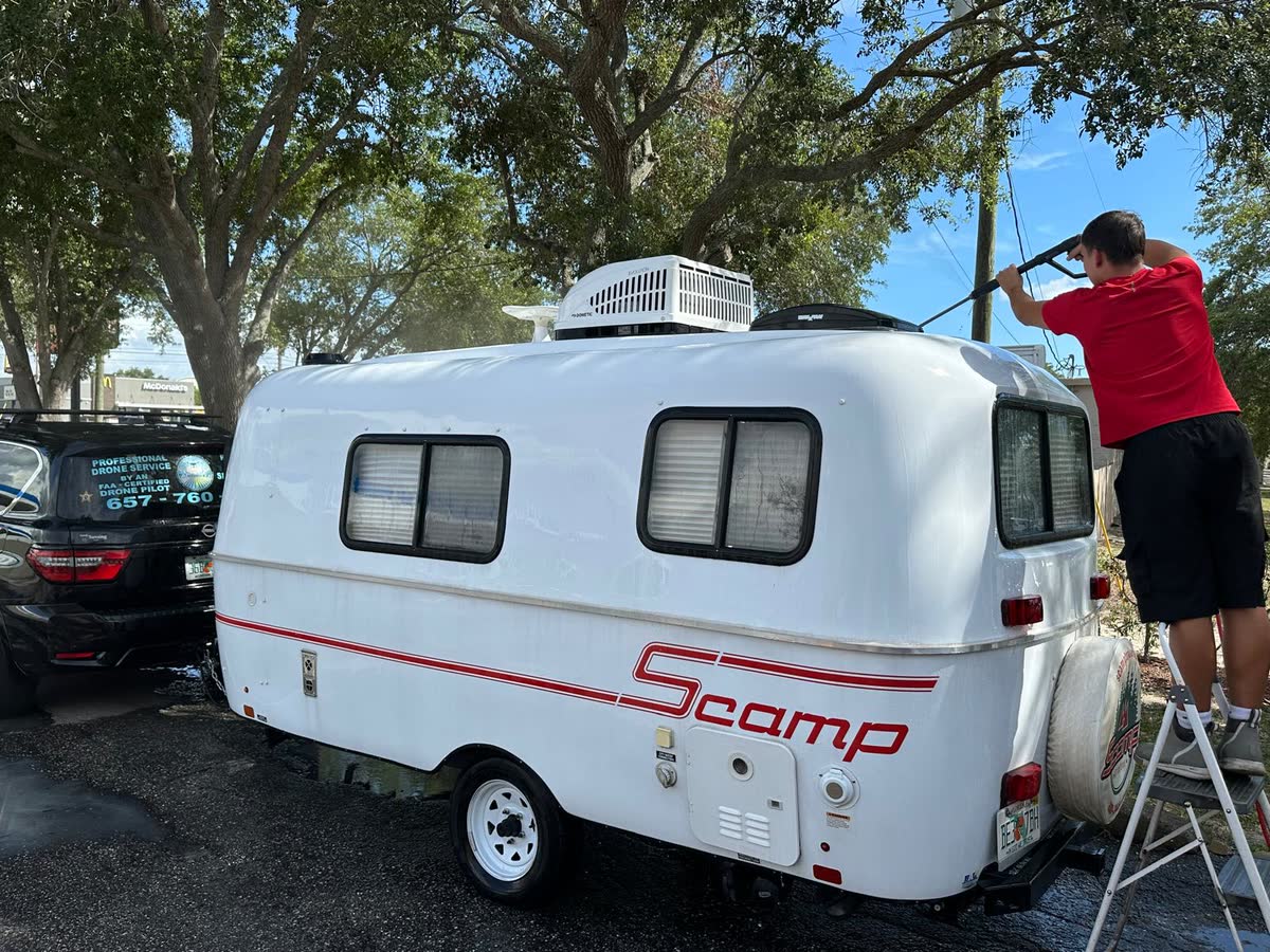White Scamp camper trailer being hand washed